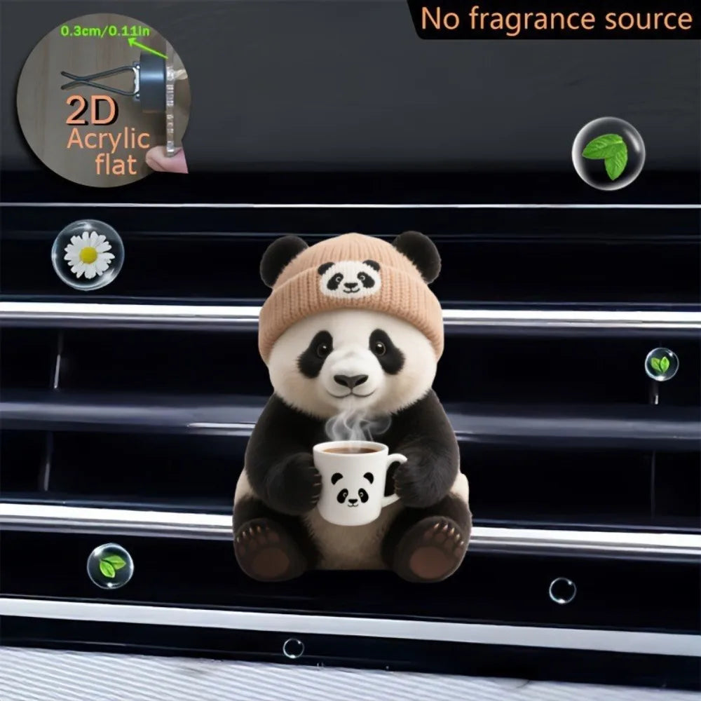 A cute panda bear plush toy holding a teacup is displayed on a black car vent clip.