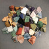 A collection of assorted natural raw crystal stones in various colors and shapes.