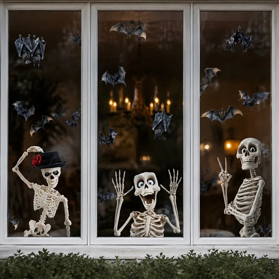 A window featuring a Halloween theme with skull and bat silhouettes and skeletal figures.