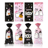 Four vertical bags of Halloween candy treats featuring a cute little boo design on pink and black backgrounds