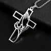 Silver pendant featuring a detailed design of prayer hands within a cross shape on a chain.