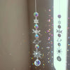 A silver crystal moon and sun wind chime decor set featuring various celestial shapes like stars, moons, and planets.