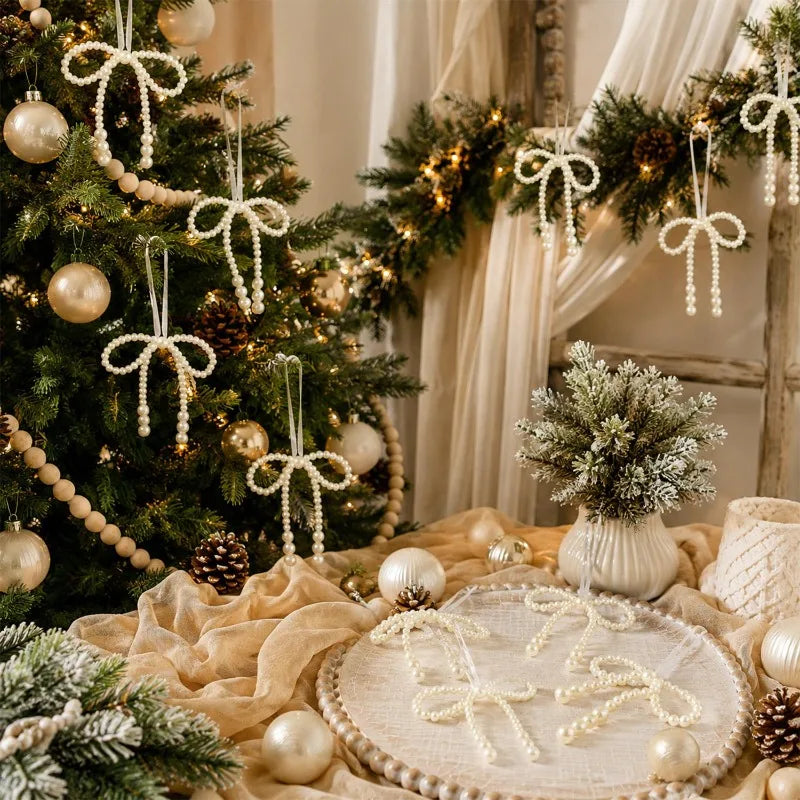 Elegant pearl bow Christmas tree ornaments and hanging decorations displayed on a rustic wooden background.