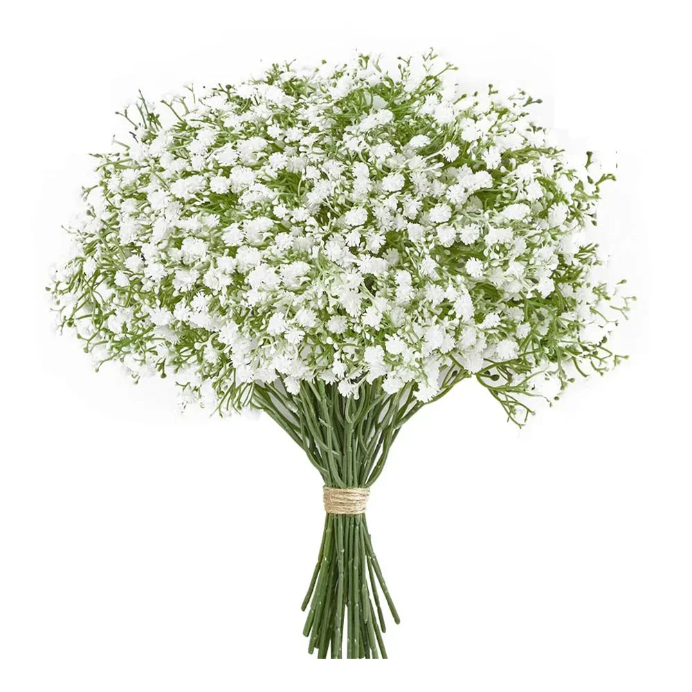 A bouquet of artificial baby's breath flowers with green stems tied together.