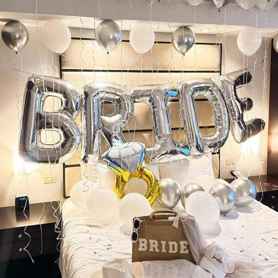 A display of silver and white letter foil balloons spelling BRIDE on a table setting.