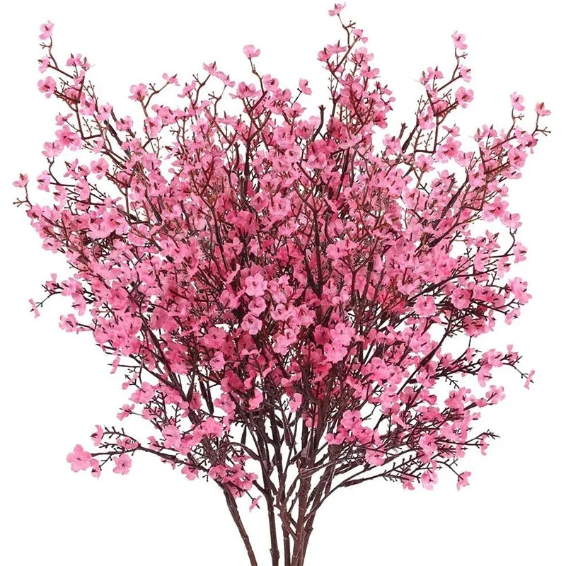 A dense branch of pink cherry blossoms and white gypsophila artificial flowers.