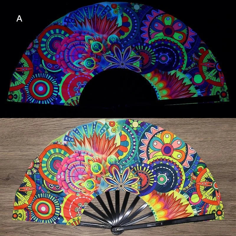 A folding fan decorated with vibrant, iridescent UV fluorescent patterns in shades of blue, pink, green, and orange.