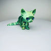 A green articulated 3D printed figurine of a Siamese cat with blue eyes.