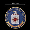 Gold-plated CIA challenge coin featuring an eagle and shield design set in a protective case.