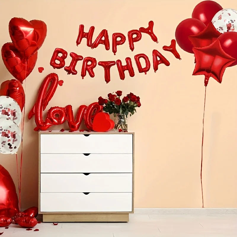 Red star and heart foil balloon decoration set with letters spelling happy birthday on a wall