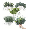 A collection of artificial eucalyptus leaves in various shades of green arranged for home decor.