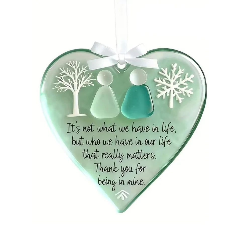 Handcrafted acrylic friendship snowflake Christmas pendant in mint green with a white ribbon.