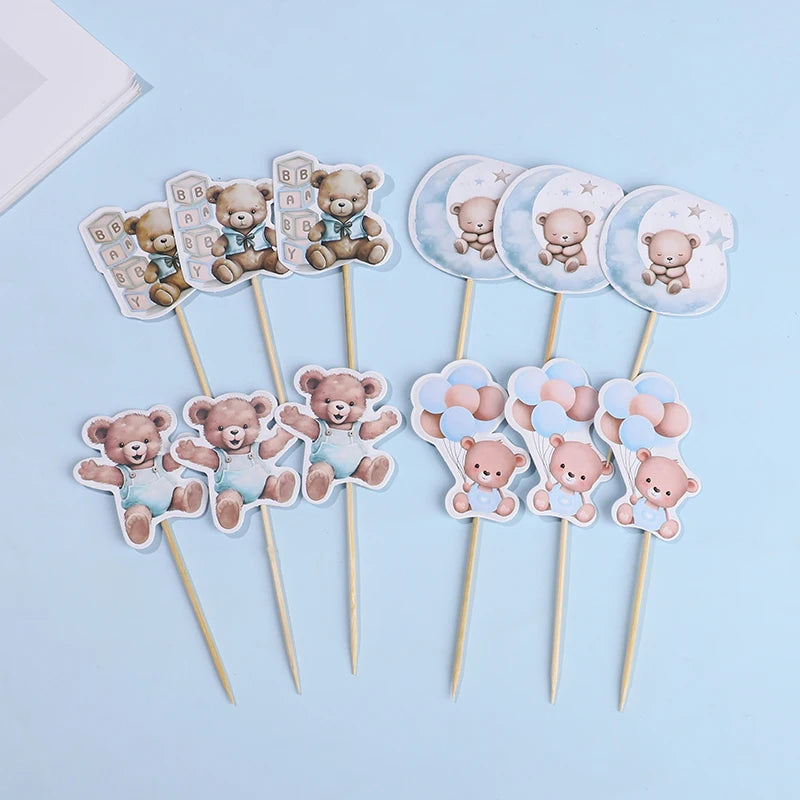 A collection of cute cartoon bear cupcake toppers on wooden sticks for baby shower and birthday parties
