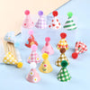 A set of mini birthday cake toppers in various colors and patterns including pink, green, and yellow.