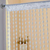 Silver beaded string curtain with white tassels used as a bohemian door and window drape.
