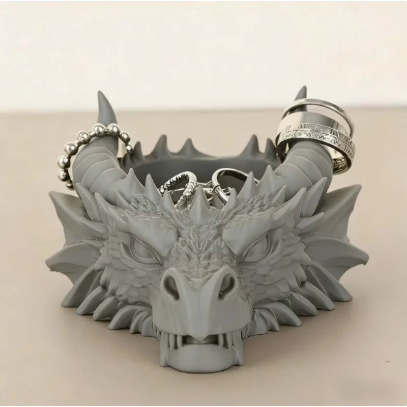 Décor de bureau en résine grise avec la tête d'un dragon, des cornes et une couronne de bagues d'argent.