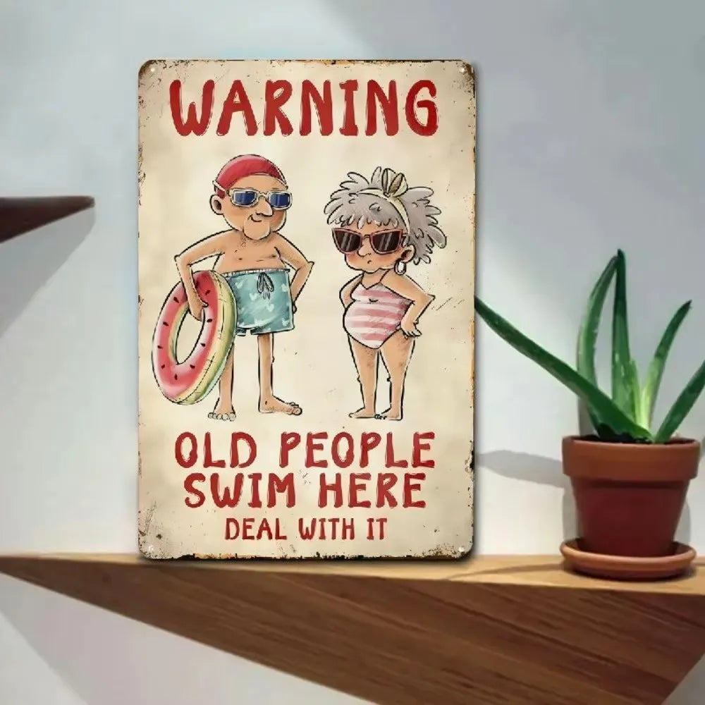 Vintage warning sign featuring cartoon figures of elderly people swimming, with text that reads Old People Swim Here Deal Wit