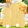 A golden sequin arch backdrop decorated with various colored balloons for a wedding or party.