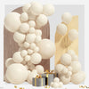 A display of white and beige latex balloons arranged in a garland arch with wrapped gifts.