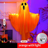Orange glowing ghost decoration hanging against a purple background