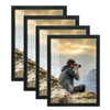 A set of four black picture frames displaying a landscape photo of a rocky mountain and sunset.