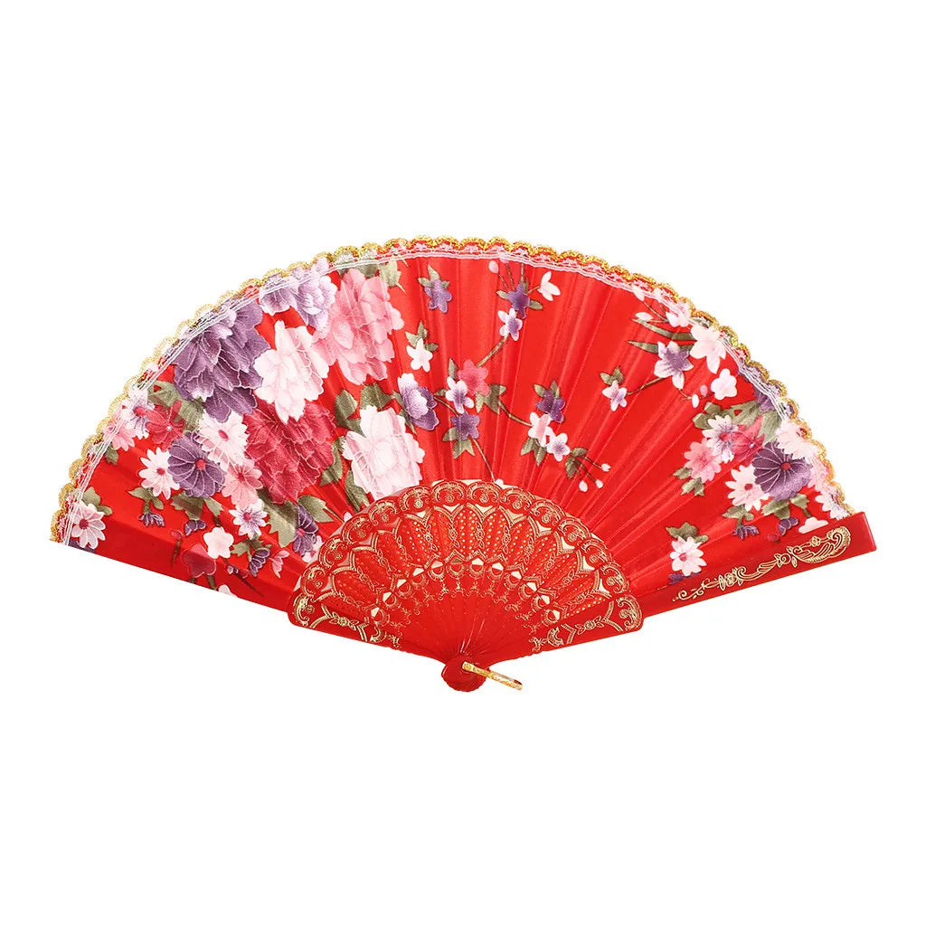 A vibrant red lace hand fan decorated with pink and purple floral patterns.