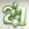 A cluster of large, light green foil number balloons forming the shape of the number 2.