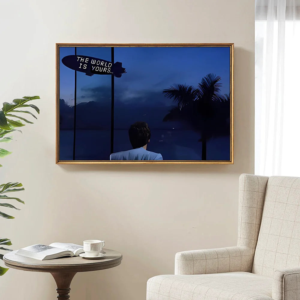 A framed canvas wall art poster featuring a silhouette of a man against a dark blue background with the text The world is you