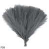 A bouquet of gray artificial reeds or pampas grass shown from above.