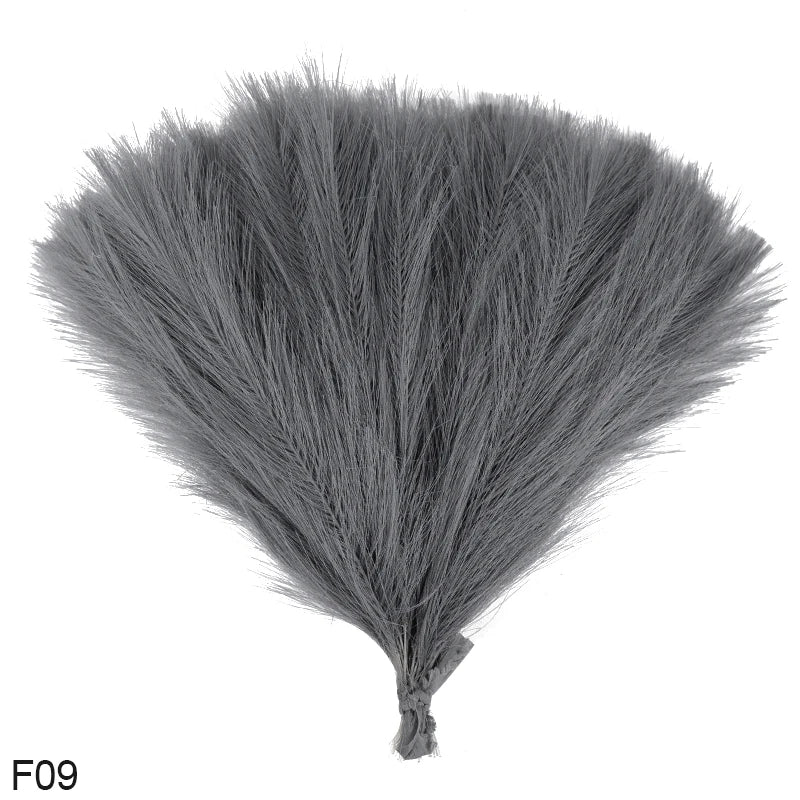 A bouquet of gray artificial reeds or pampas grass shown from above.