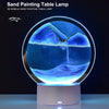A 3D mobile sand painting table lamp illuminating a blue and purple landscape on a round base.