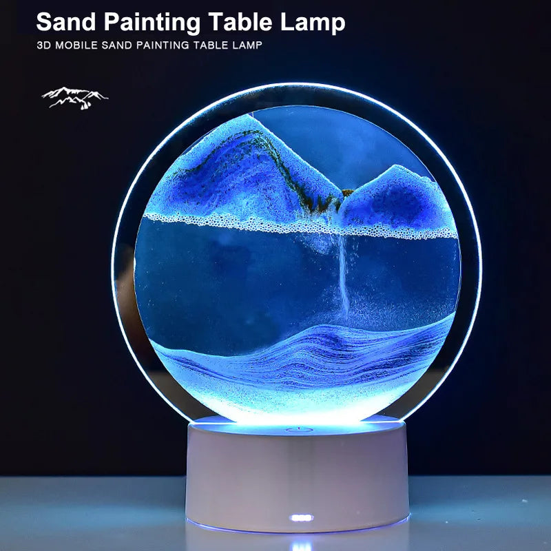 A 3D mobile sand painting table lamp illuminating a blue and purple landscape on a round base.