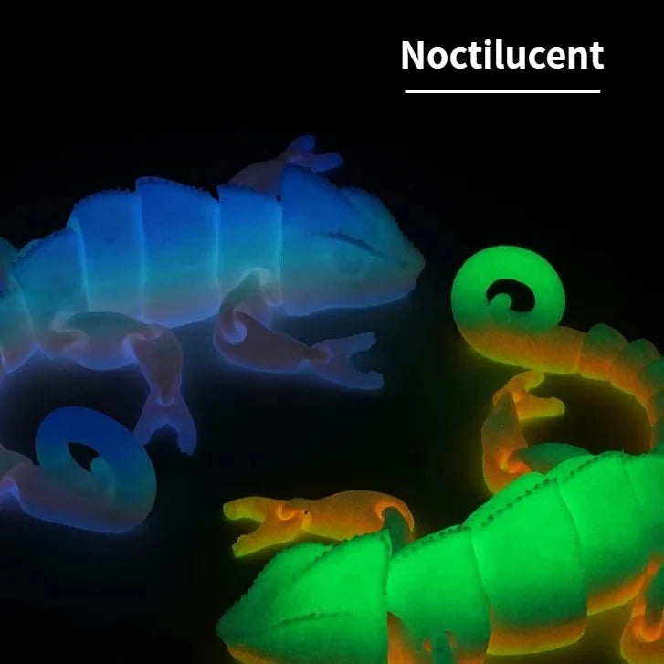 A close-up image of a noctilucent dragon lizard figurine glowing with blue and green light against a dark background.