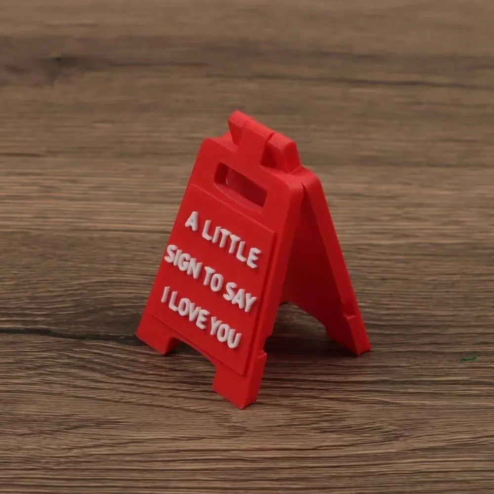 A red 3D printed letter sign ornament shaped like an arrow with the text I love you inside
