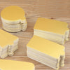 Stacks of metallic gold and silver dessert cake boards on a wooden surface.
