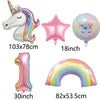 A set of foil balloons including a unicorn, a star, a number one, and a rainbow arch for a party decoration