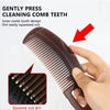 A hand gently presses the teeth of a dark brown comb to squeeze out dirt, demonstrating its cleaning function.