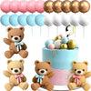 A collection of teddy bear cake toppers in various colors and finishes for a gender reveal party.