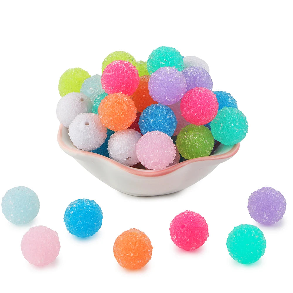 A pile of colorful textured resin beads in various shades including pink, green, blue, and orange.