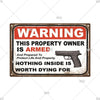 A vintage metal warning sign with the text WARNING THIS PROPERTY OWNER IS ARMED And Prepared To Protect Life And Property NOT