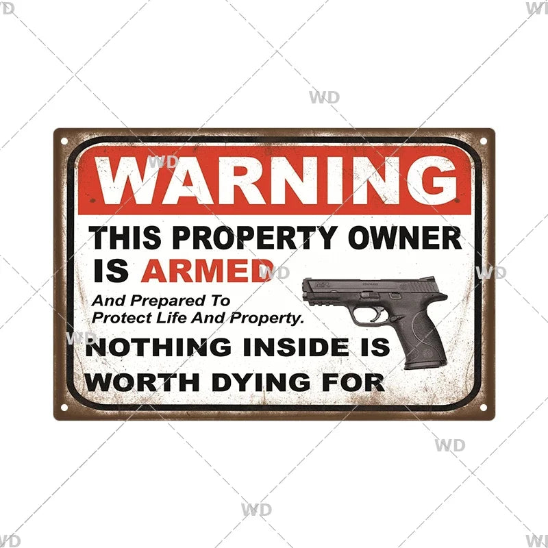 A vintage metal warning sign with the text WARNING THIS PROPERTY OWNER IS ARMED And Prepared To Protect Life And Property NOT