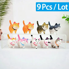 A lot of nine adorable mini cat figurines in various colors and patterns displayed on a white surface.