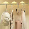 A set of metal hat storage hooks hanging on a bar, with various hats and scarves displayed.