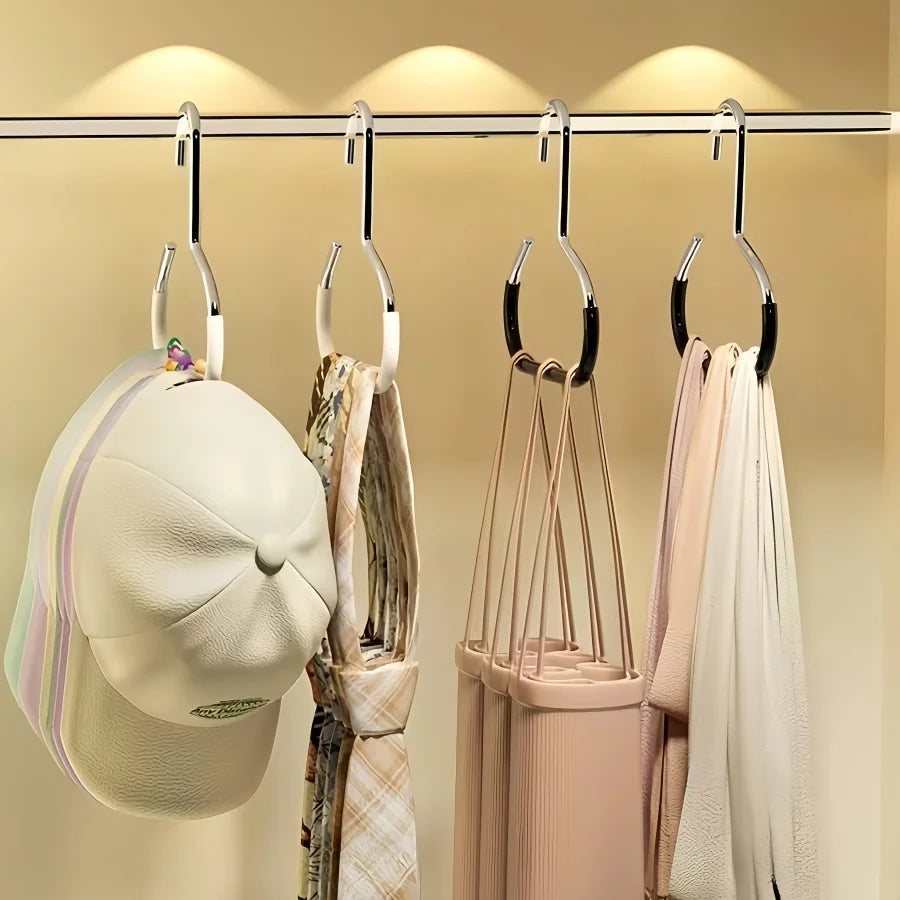 A set of metal hat storage hooks hanging on a bar, with various hats and scarves displayed.