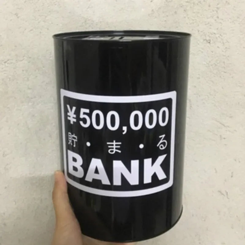 A black cylindrical piggy bank with white Japanese text reading 500,000 yen and the word BANK.