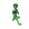 A green resin statue of an alien holding a beer mug.