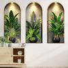 Three framed botanical prints featuring lush green potted plants and vines on a white wall.