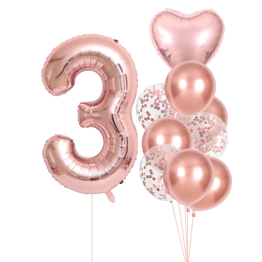 A set of rose gold foil balloons shaped like the number three and heart for party decoration
