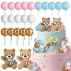 A tiered cake decorated with teddy bear toppers and pastel balloons for a gender reveal party.