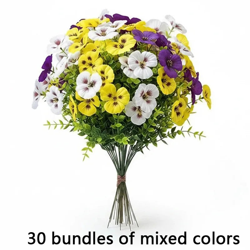A bouquet of mixed artificial pansy and daisy flowers in yellow, white, and purple colors.